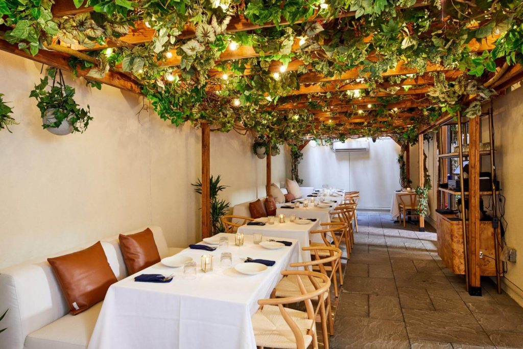 A restaurant room decorated to look like an outdoor patio