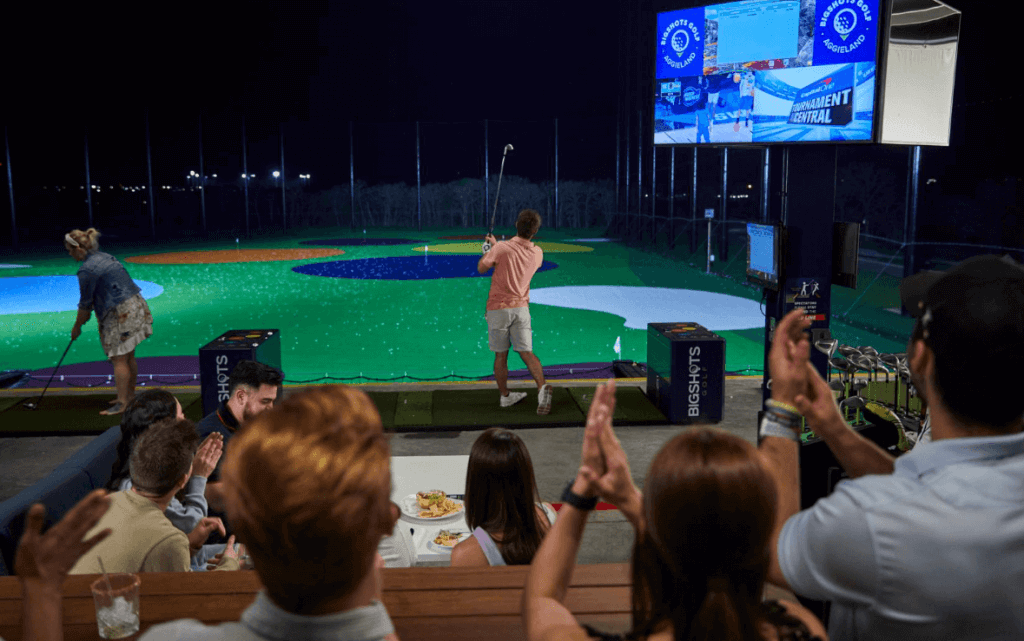 group of people at golf bays playing and cheering